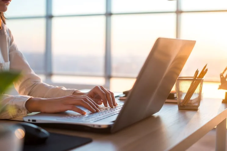 hands typing on a laptop
