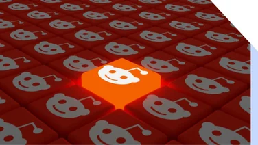 Rows of red cubes with the Reddit logo on with one cube raised higher and glowing in light