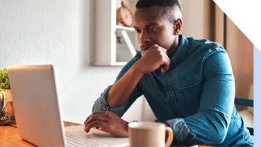 Man concentrating as he looks at a laptop
