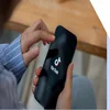 Person holding a phone with the TikTok logo on display