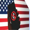 Hand holding phone with a banned TikTok logo, against a backdrop of the US flag