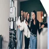 three ladies standing in front of a phone on a tripod