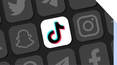 Different social media logos in black and white with the TikTok logo in colour at the centre