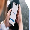 Person holding a phone with the LinkedIn sign up page on the screen