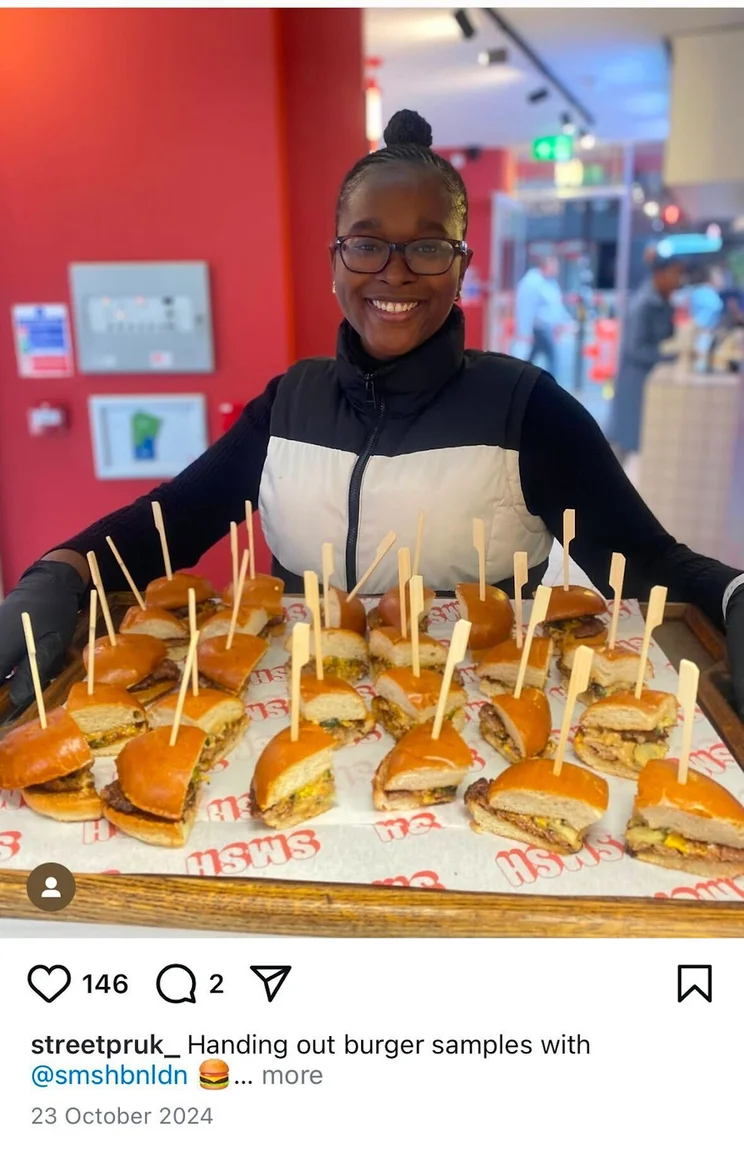 woman holding a large tray of burger samples
