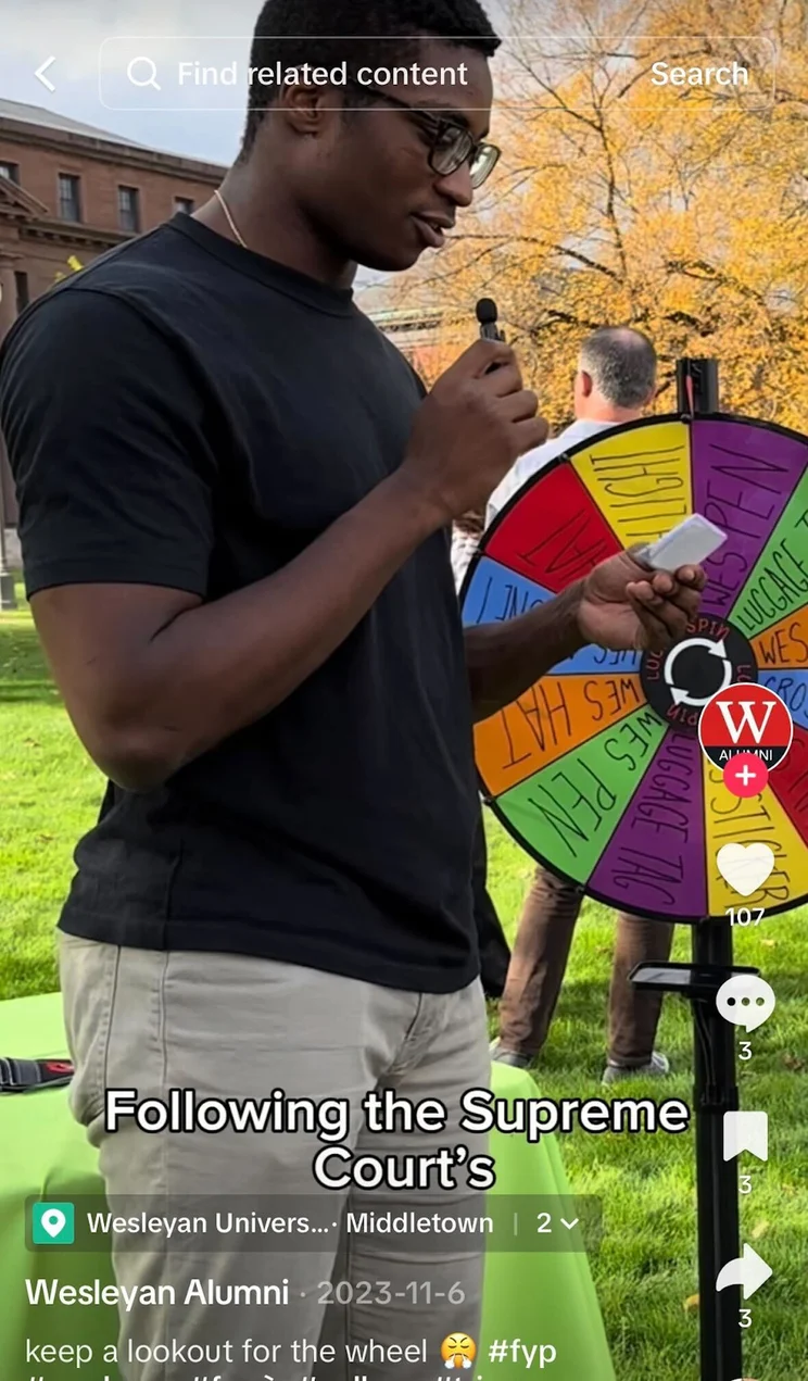 tiktok video of a man spinning a multicolored prize wheel