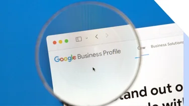 Magnifying glass hovering over a browser showing the Google Business Profile homepage