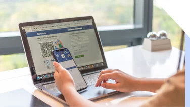Facebook log in page on laptop and mobile