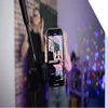 A man and a woman dance on a smartphone camera. A view of the phone screen standing on a tripod