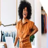 Women laughing as she stands next to her laptop