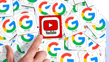A finger pointing to a YouTube logo on top of many Google logos