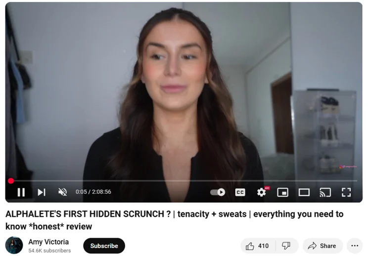 woman with brown hair filming youtube review of gymwear