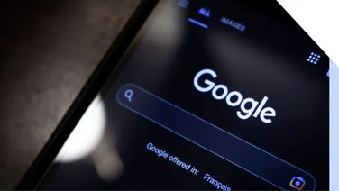 Closeup of Google search on a phone in dark mode
