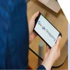 man holding phone with google shopping logo on it