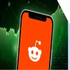A phone with the reddit logo on screen