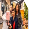 Three people posting in front of a phone on a tripod