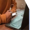 balled fist waiting by a laptop screen that says "loading"