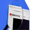 youtube advertising page on laptop screen covered by magnifying glass