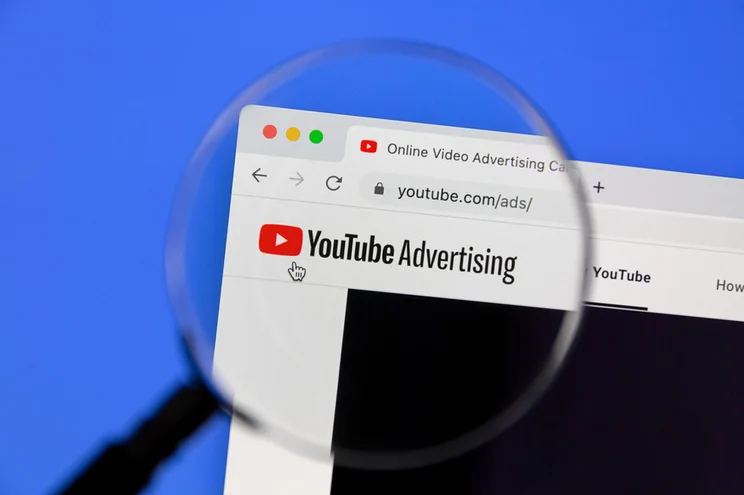 youtube advertising page on laptop screen covered by magnifying glass