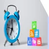 a blue alarm clock next to multicolored wooden blocks with social media icons on