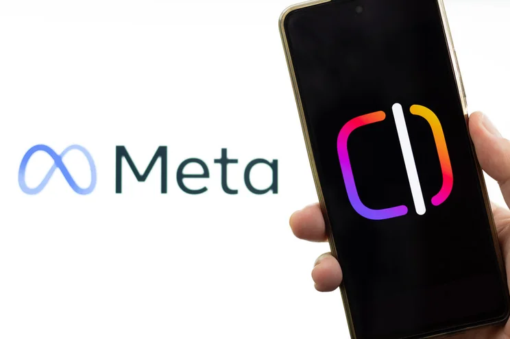 Instagram Edits logo on a phone held next to the logo of its parent company, Meta