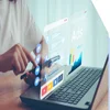 a woman tapping a smart phone with a laptop open in front of her and the word "ads" popping out the screen