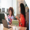 Two woman working and discussing a business plan
