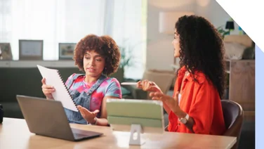 Two woman working and discussing a business plan