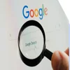 Magnifying glass hovering over the Google homepage search bar