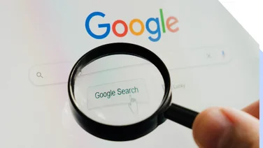 Magnifying glass hovering over the Google homepage search bar