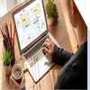 A man using his laptop with a homepage wireframe on the screen