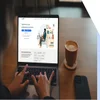 Hands typing on a laptop with LinkedIn on the screen