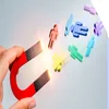 Magnet attracting small models of multi-colored people