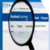 A magnifying glass positioned over a monitor with "Facebook Business" on screen