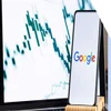 A smartphone on a stand with the Google logo on screen