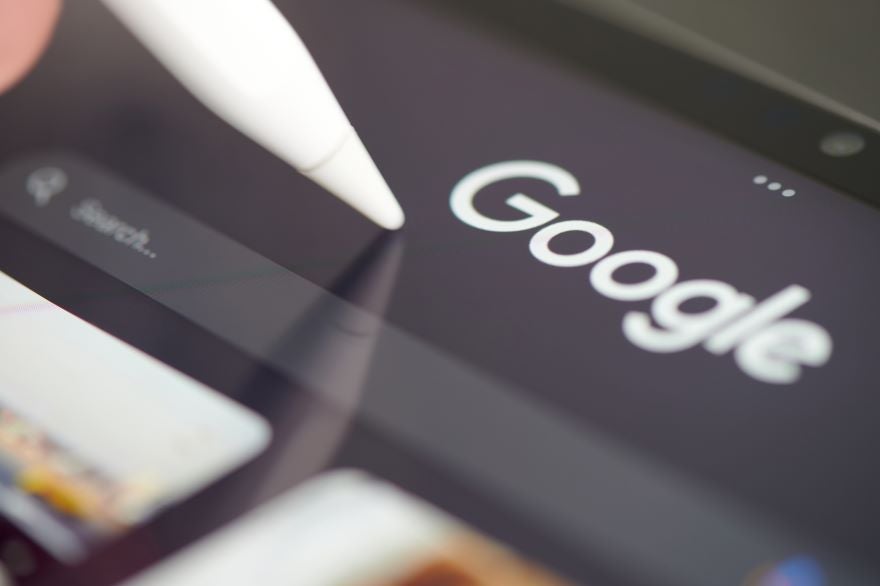 Google Retired Structured Data In Article Image Closeup of a tablet screen with the Google logo and a stylus tapping it