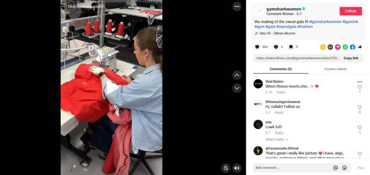 TikTok frame of a woman sewing a red garment at a sewing machine, surrounded by spools of thread in a bright workshop.