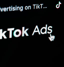 Close up of tiktok ads logo on digital screen
