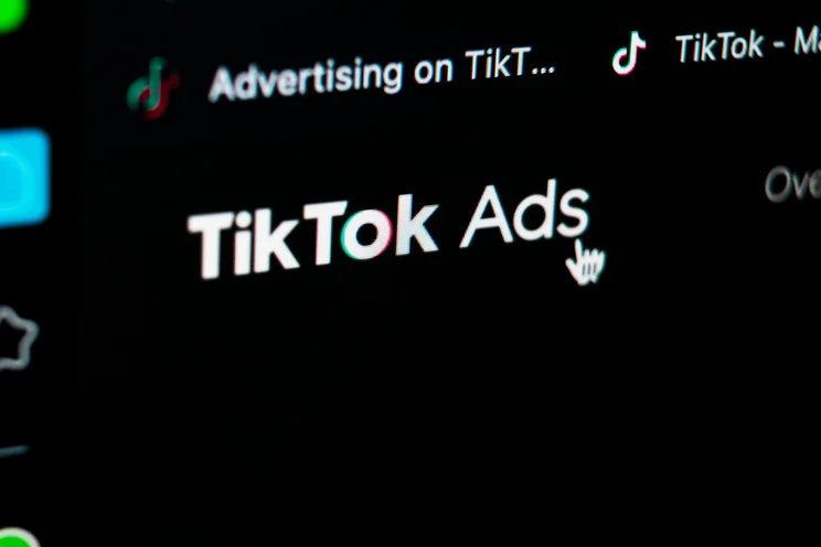 Close up of tiktok ads logo on digital screen