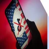 Phone screen showing a collage with the TikTok logo placed on top of the American flag and there's a red cross through the logo