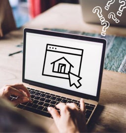 A person types on a laptop, displaying a home icon on the screen, surrounded by question marks, suggesting confusion or inquiry.