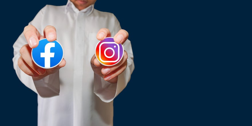 Crossposting on Facebook and Instagram Intro Person in white shirt holding up a sticker of the Facebook logo and the Instagram logo in each hand