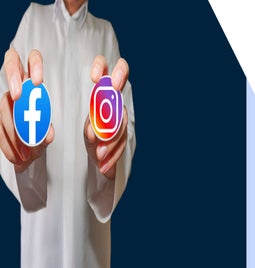 Person in white shirt holding up a sticker of the Facebook logo and the Instagram logo in each hand