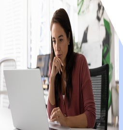 Woman focused as she works at a laptop