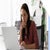 Woman focused as she works at a laptop