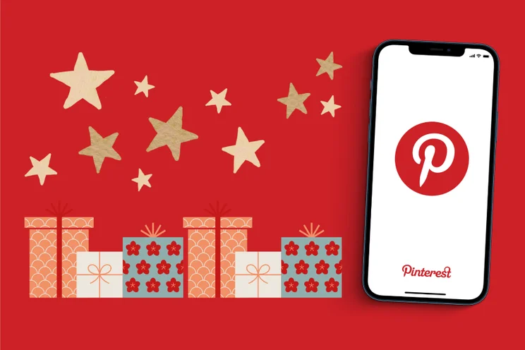 A red background features festive gifts and gold stars alongside a smartphone displaying the Pinterest logo.