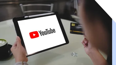 person holding ipad with YouTube logo full screen