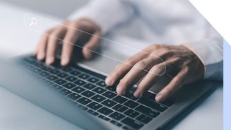 Hands typing at a laptop keyboard with a search bar image floating above