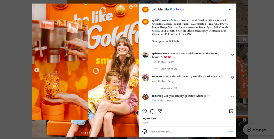 Goldfish Brand Activiation A person enjoys Goldfish crackers in a vibrant, orange-themed setting with various flavored snacks on display in the background.