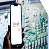 A hand holds a smartphone displaying the Google Reviews logo against a blurred circuit board background.